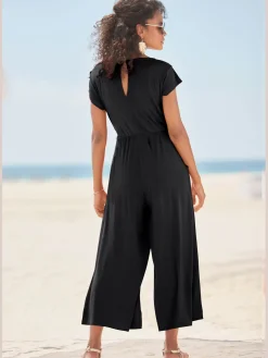 Combinaison pantalon large encolure ronde avec fermeture boutonnée au dos