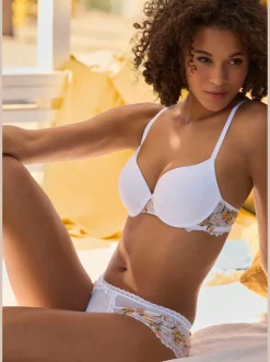 Tanga féminin avec petit nœud décoratif et perle au centre devant