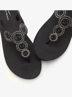 Tongs avec semelle imperméable et applications brillantes